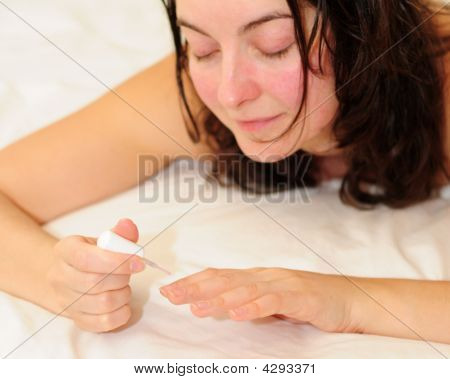 Young Woman Using Nail Polish