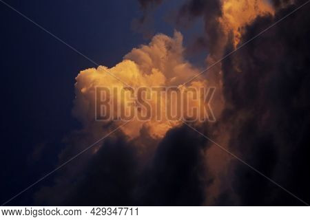 Group Of Golden Clouds Reflecting The Sunset.a Fearful Look Was A Sign Of An Impending Storm.