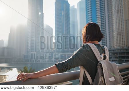 Happy Young Female Traveler In The Big City Of Dubai, Famous Place Dubai Marina. Luxury And Comforta