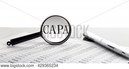 Magnifying Glass With Text Capa On Background With Pen