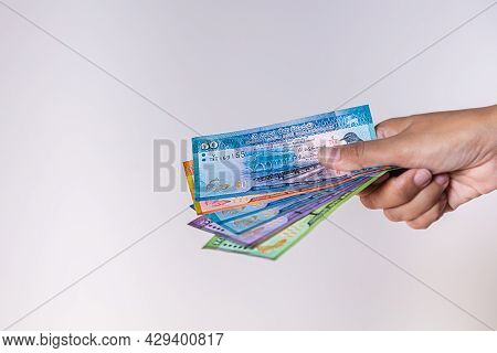 Sri Lanka Rupees  Banknote In Female Hand. Woman's Hands Show Sri Lanka Rupie Money. Girls Hands Hol