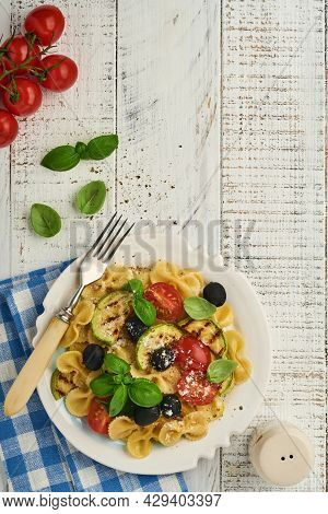 Pasta Fiocchi Salad With Vegetables Grilled Zucchini, Cherry Tomato, Olives, Basil And Parmesan Chee