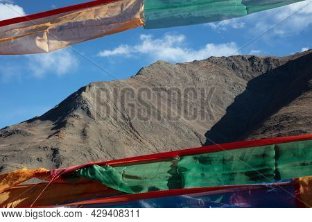 Prayer Flags In Front Of The Mountains Of The Himalaya. The Amazing Landscape Of Tibet. Colorful Pra