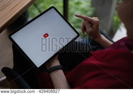 Chiang Mai, Thailand - Aug 09, 2021 : Woman Using A Tablet To Connect To Youtube Premium. Youtube Is
