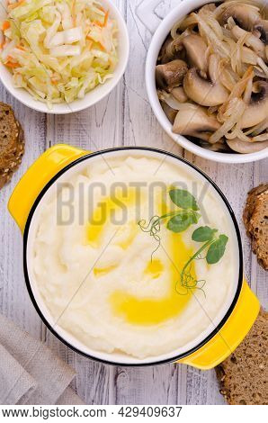 Mashed Potatoes With Butter, Fried Mushrooms With Onions And Salad Of Fresh Vegetables On Light Wood