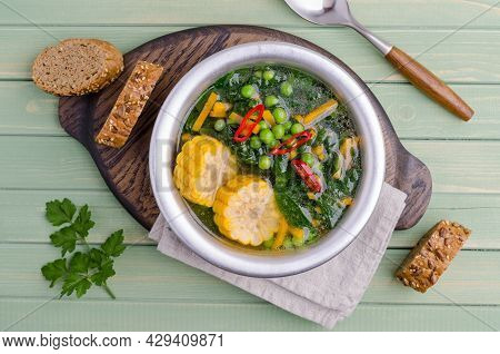 Vegetable Transparent Soup In A Ceramic Dish On A Wooden Background. Selective Focus.
