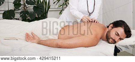 Treatment Of Back Pain With Acupuncture Needles For Man Patient. Traditional Chinese Medicine
