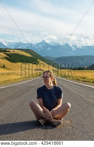 Woman om the Chuysky trakt road in the Altai mountains. One of the most beautiful road in the world.