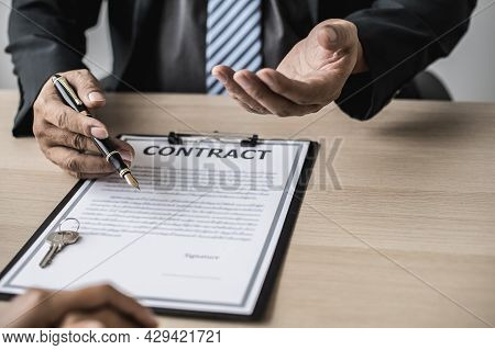 The Employee Is Explaining The Rent Details And Calculating The Monthly Rent To The Tenant Before Si