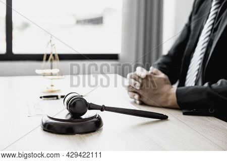 A Small Court Judge's Hammer Is Placed On The Lawyer's Table, The Lawyer Is Advising The Client To H