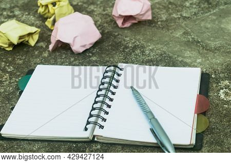Notebook Pen And Crumpled Paper On Rustic Floor. Mistake Learning, Wrong, Blooper, Error, Regret Say