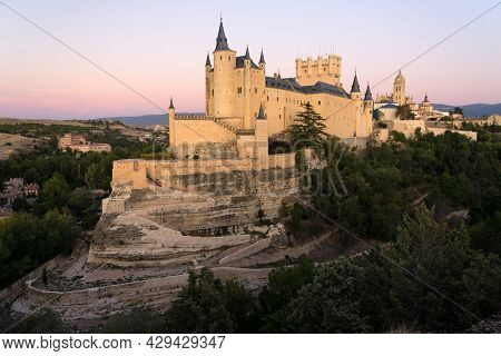 View Of The Alcazar Fortress And St Mary Cathedral Of Segovia With Alpenglow In The Background, List
