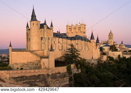 View Of The Alcazar Fortress And St Mary Cathedral Of Segovia With Alpenglow In The Background, List