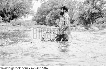 Summertime. Hobby And Sport Activity. Pothunter. Mature Man Fly Fishing. Man Catching Fish. Bearded 