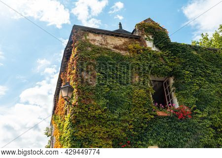 Houses Full Of Green Leaves In The Medieval Village Of Rochefort-en-terre, Morbihan Department In Th