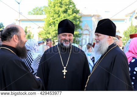 Orthodox Priests In Church Clothes Stand On The Street In Kiev. A Religious Rite, A Holiday At A Chr