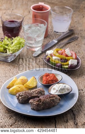 Greek Feta Filled Bifteki And Fries On Wood