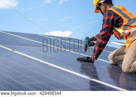 Professional Worker Working And Installing Solar Panels At Solar Power Plant,innovative Solution For