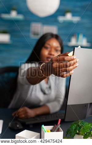Student With Dark Skin Putting Stickey Notes On Computer Studying Communication Lesson Using Univers