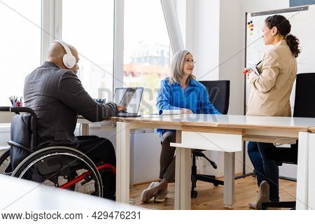 Group of multiethnic colleagues having a meeting with blankboard in the office
