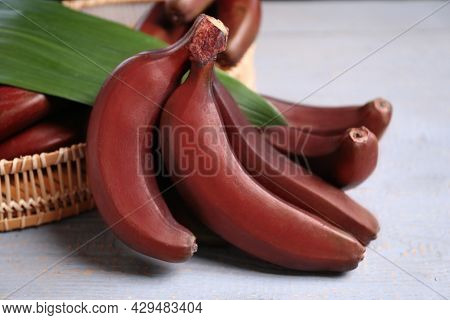 Tasty Red Baby Bananas On Grey Table, Closeup