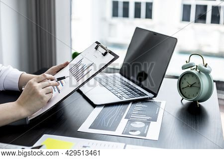 Woman Pointing To A Sales Data Sheet, A Sales Manager Is Looking At A Sales Summary Of Employees In