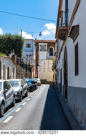 Sorrento, Italy - August 26 2020: Street View To Narrow Road Full Of Cars With Clock Tower At The En