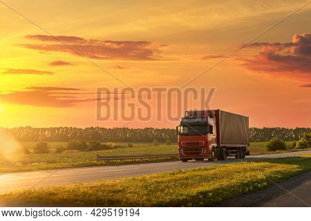 Scenic Front View Big Long Heavy Semi-treailer Truck With Sea Shipping Container Driving Highway Dra