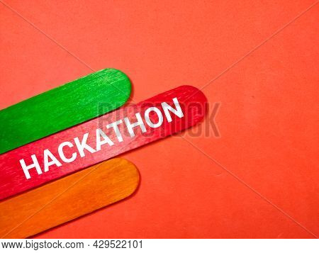 Business Concept.text Hackathon Writing On Colored Ice Cream Sticks On A Red Background.