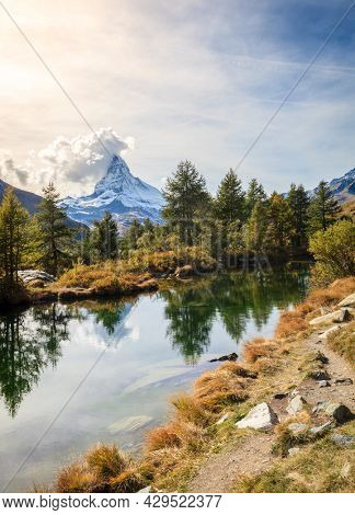 Famous alpine peak Matterhorn refleced in a pond in Swiss Apls