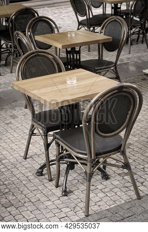 An Empty Table With Two Chairs In A Restaurant.