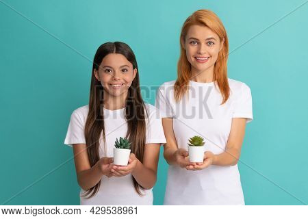 Happy Adoptive Family Of Adopted Daughter Child And Woman Mother Smile Holding Houseplants, Adoption