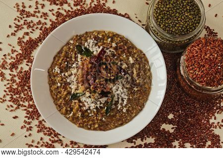 Porridge Or Gruel Made Of Navara Rice, Mung Beans And Fenugreek Seeds Sprinkled With Fresh Grated Co