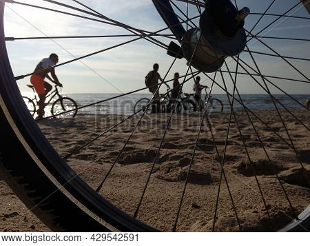 View Of A Group Of Cyclists On The Beach