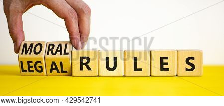 Legal Or Moral Rules Symbol. Businessman Turns Wooden Cubes And Changes Words 'legal Rules' To 'mora