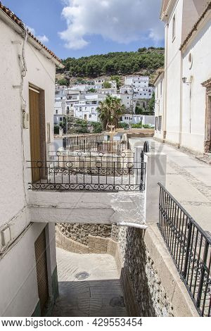Streets In Murtas At Different Levels With Walkway Access, Flowerpots And White Houses In The Backgr