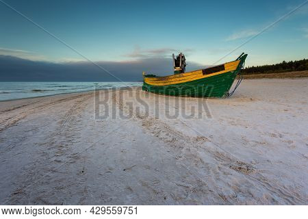 A Fishing Wooden Boat Moored By The Beach In Debki, Sunrise. Baltic Sea, Northern Poland.