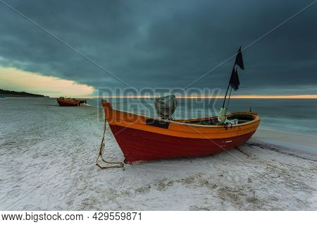 A Fishing Wooden Boat Moored By The Beach In Debki, Sunrise. Baltic Sea, Northern Poland.