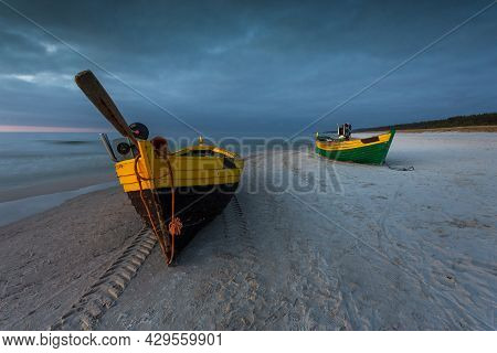 A Fishing Wooden Boat Moored By The Beach In Debki, Sunrise. Baltic Sea, Northern Poland.
