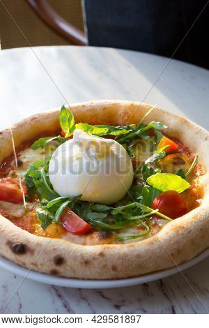 Buratta Cheese On A Neapolitan Pizza On A Cafe Table