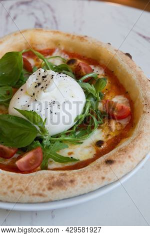Buratta Cheese On A Neapolitan Pizza On A Cafe Table