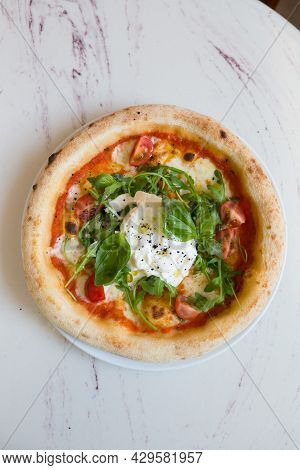 Buratta Cheese On A Neapolitan Pizza On A Cafe Table