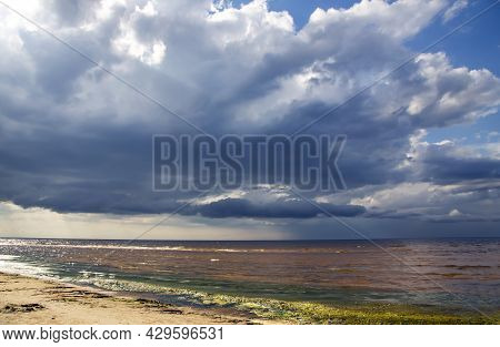 Big Rain Clouds Over Wild Sandy Coast Reflected In A Small Shallow Of The Baltic Sea In Vecaki, Latv