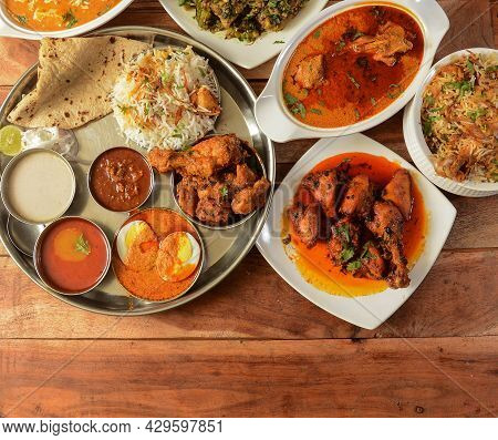 Assorted Indian Foods Pepper Chicken Gravy,chicken Masala And Nonveg Thali On Wooden Background. Dis