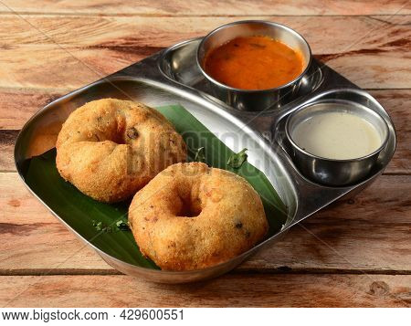 Indian Fried Snack Medu Vada With Sambar And Coconut Chutney In Plate On Rustic Wooden Background, S