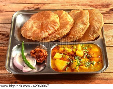 Puri Sabji - Indian Semi Dry Potato Spicy Recipe Also Known As Batata Or Aloo Ki Sabji, Served With 
