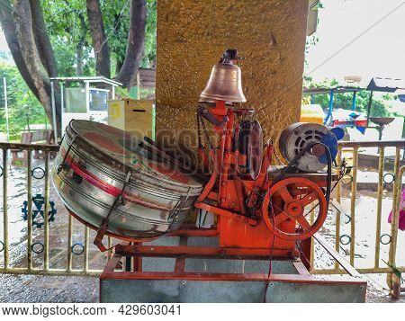 Stock Photo Of Orange Color Automatic Drum Bell Machine Or Player , It Include Drum With Tow Sticks 