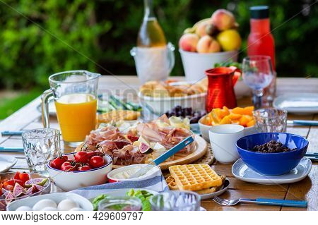 A Beautifully Laid Table On The Terrace For A Large Family.nice Breakfast For A Big Company.breakfas