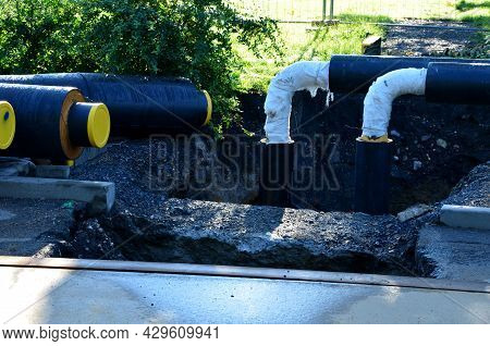 Installation Of Hot Water Pipes For Heating Apartments. Insulated Pipes Are Laid In The Road For San
