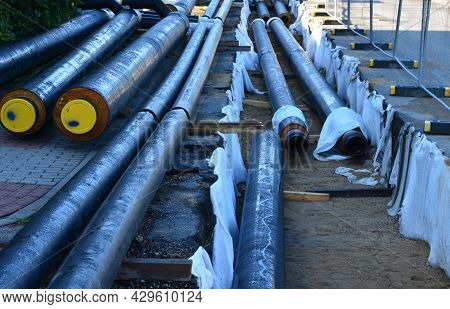 Installation Of Hot Water Pipes For Heating Apartments. Insulated Pipes Are Laid In The Road For San